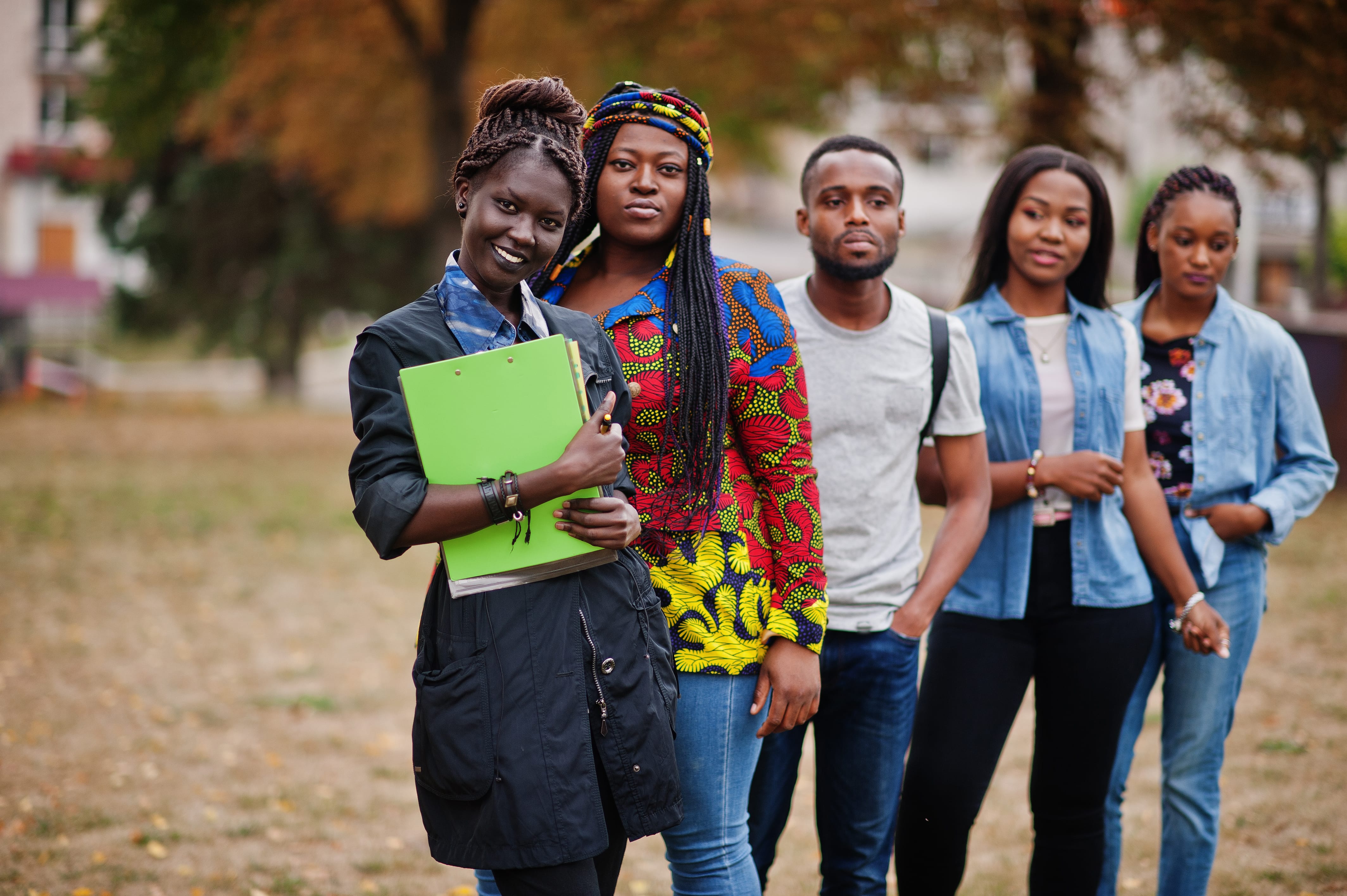 row group five african college students spending time together campus university yard black afro friends studying education theme