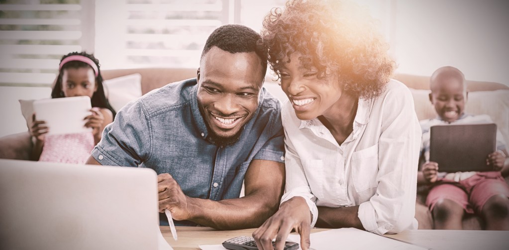 couple sitting table calculating bills