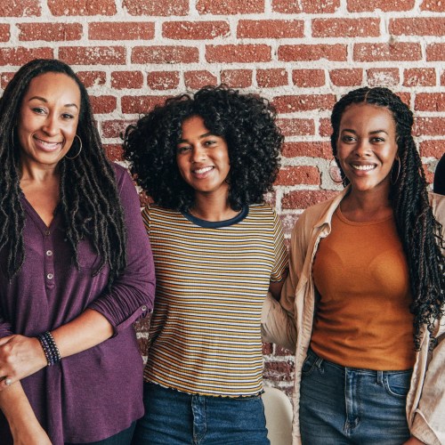 cheerful black people standing front red brick wall cheerful black people standing front red brick wall